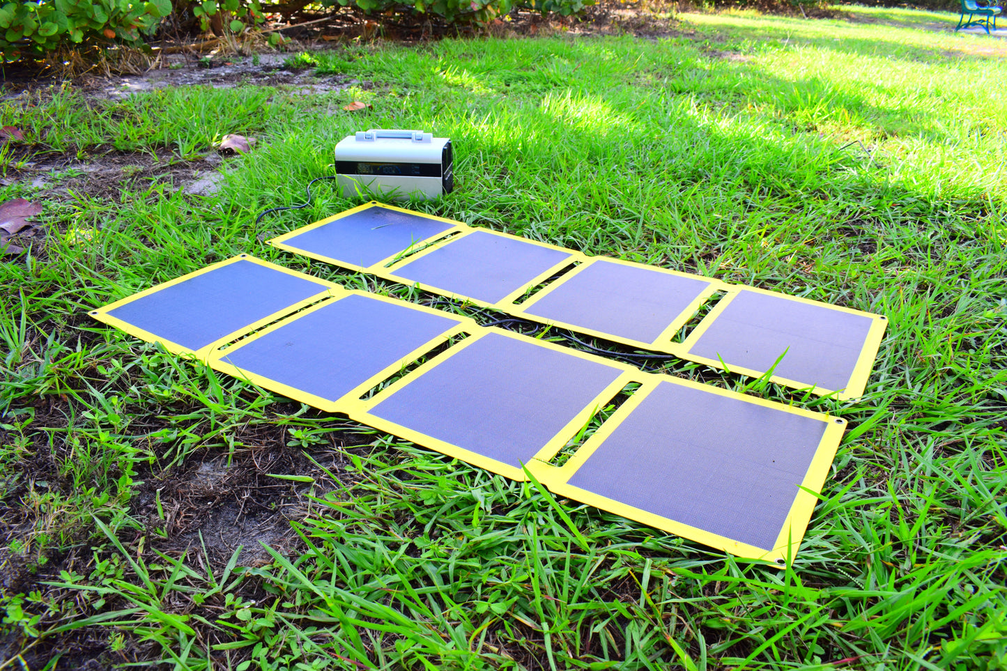 SunJack Y-Branch Parallel Adapter Splitter Cable 10ft connected to solar panels in a grassy outdoor setting.