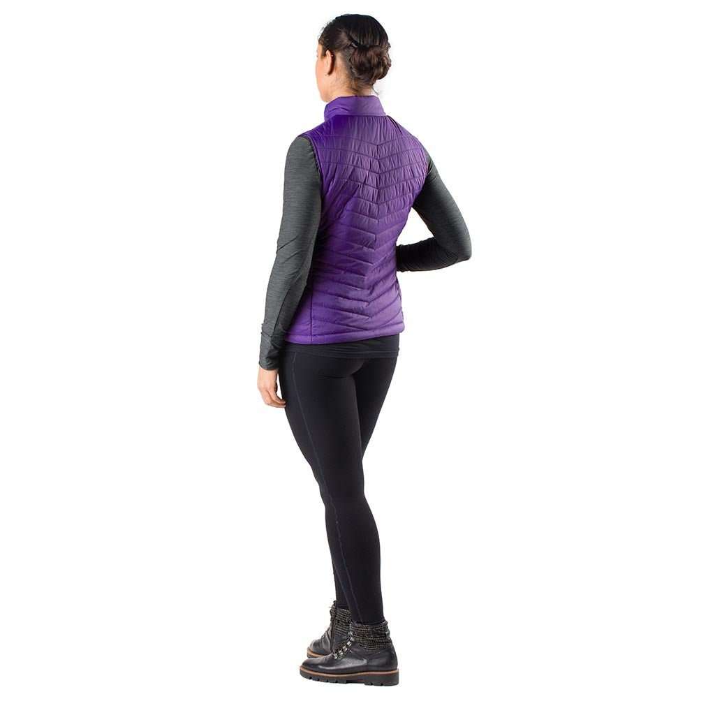 Woman wearing Dune Heated Vest in Plum color, suitable for cold weather.