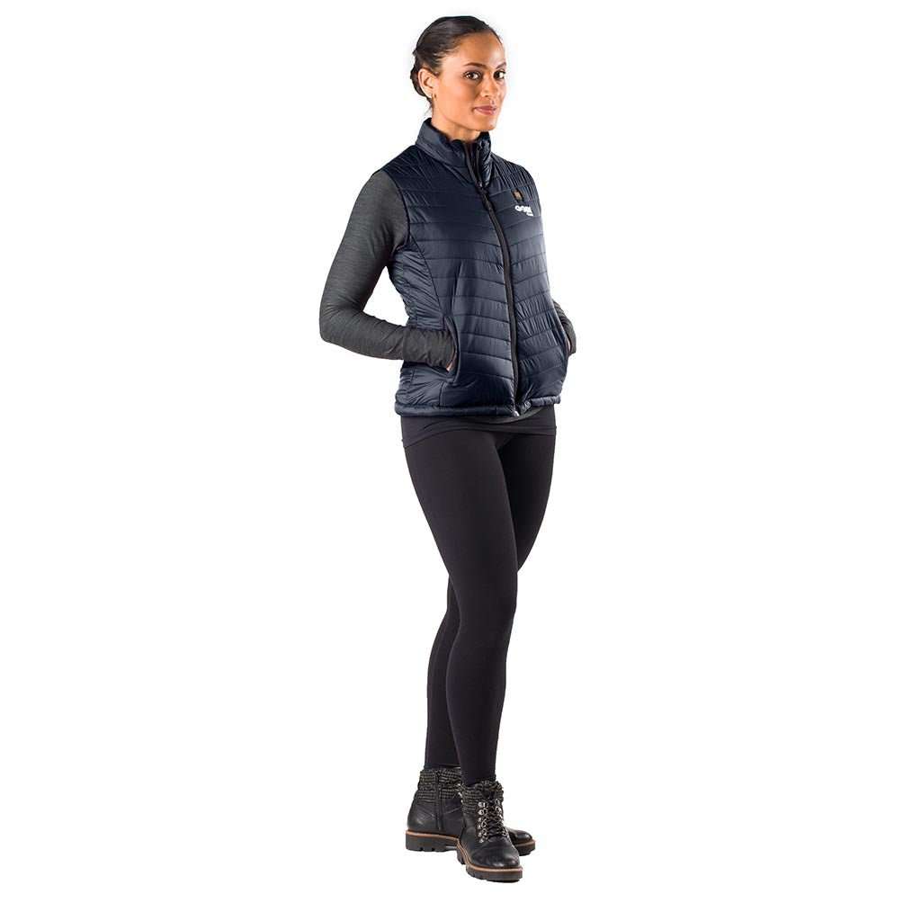 Woman wearing Dune Heated Vest in Onyx, featuring lightweight nylon and conductive heating for up to 10 hours of warmth.