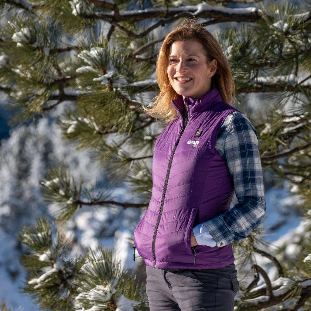 Dune Heated Vest for Women in Plum color, worn outdoors in a snowy landscape.