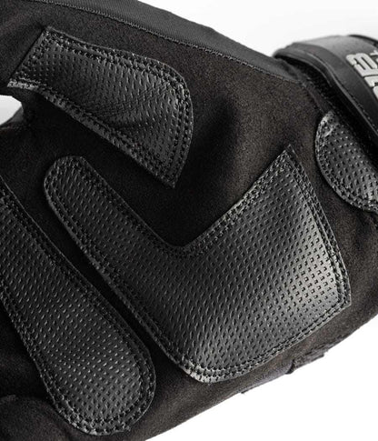 Close-up view of black Exxtremity Patrol Gloves 2.0 with textured synthetic-leather palm.