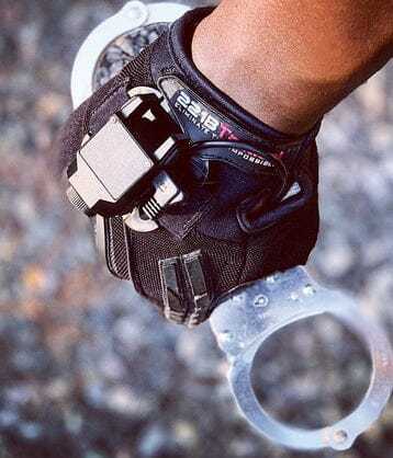 Guardian Gloves Pro providing superior hand protection and grip while holding handcuffs.