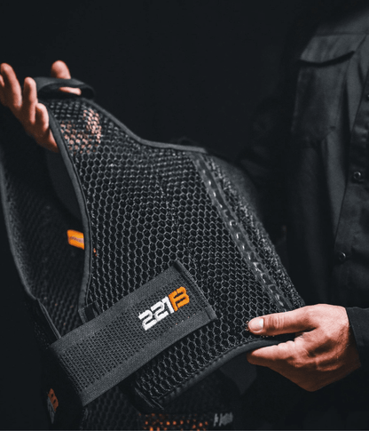 Maxx-Dri Vest 5.0 with breathable mesh design held by a person in black clothing.