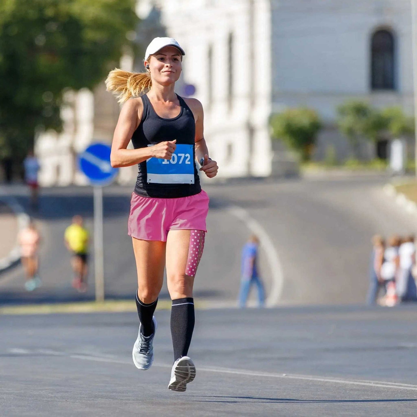 Runner wearing KT Tape Pro® for support during a race.