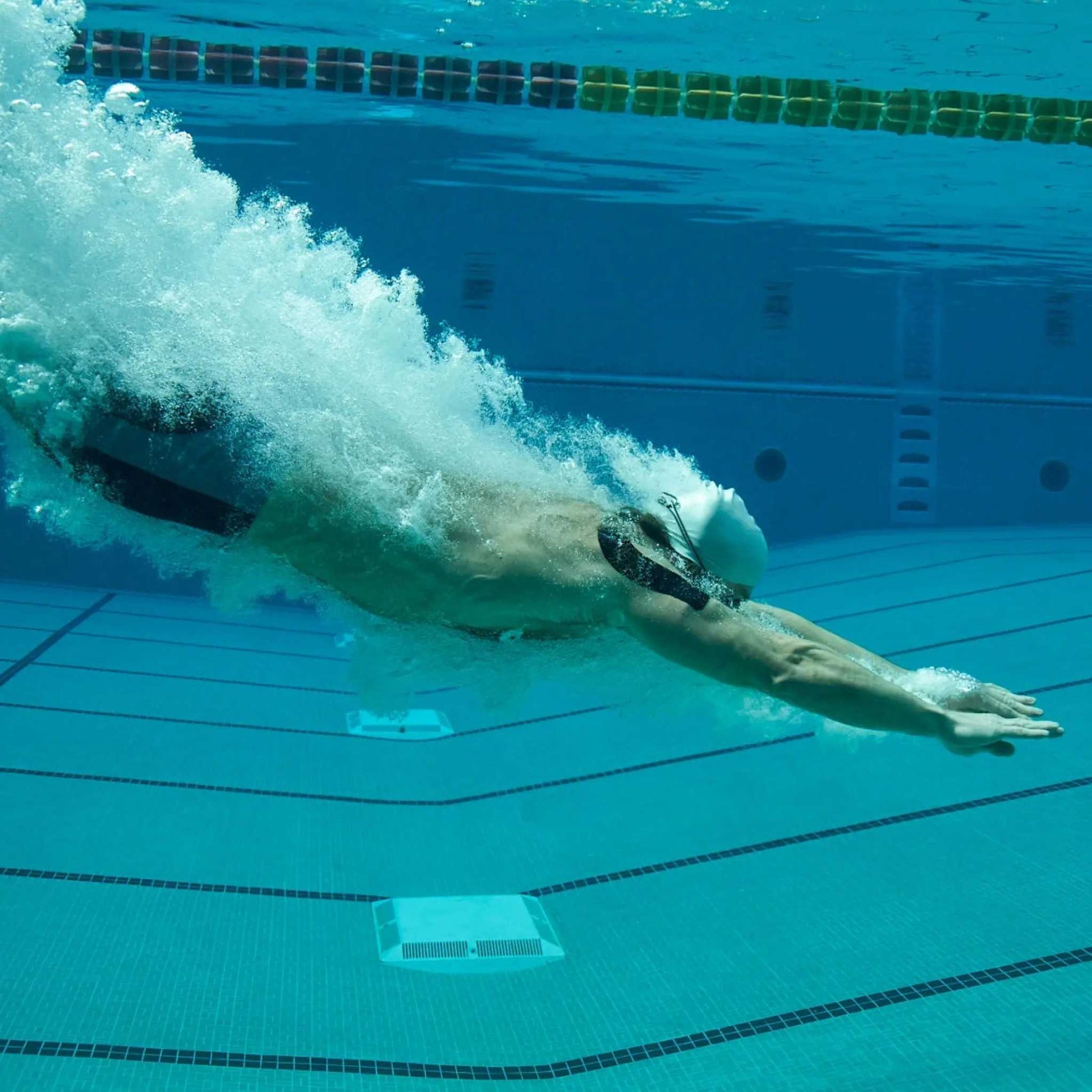 Swimmer using KT Tape Pro Extreme® underwater for support in extreme conditions.