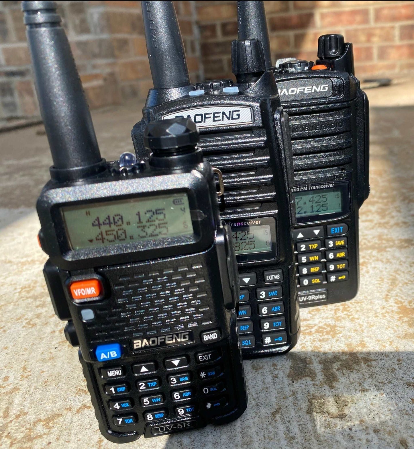 Handheld radios programmed with GMRS, NOAA Weather frequencies, and local ham repeaters.