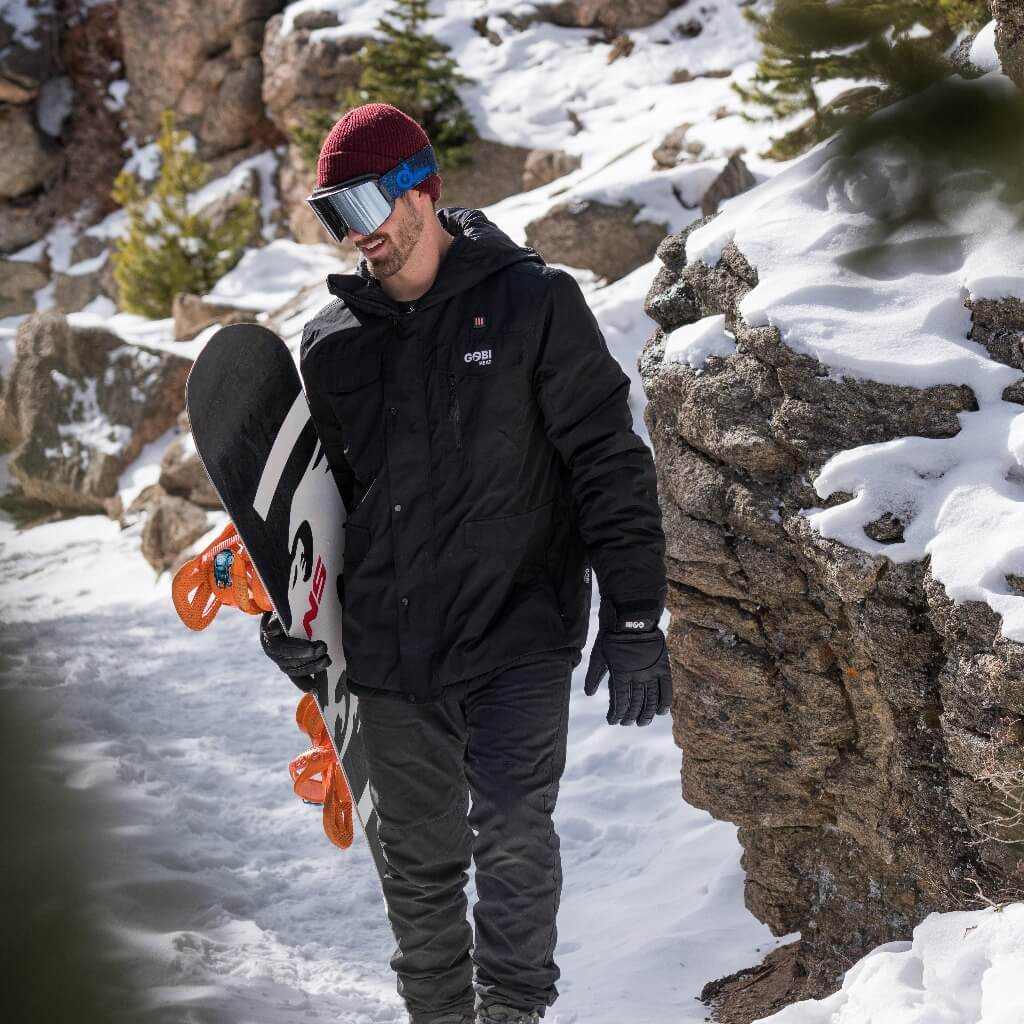 Shift Mens Heated Snowboard Jacket in snowy landscape, winter sports gear.