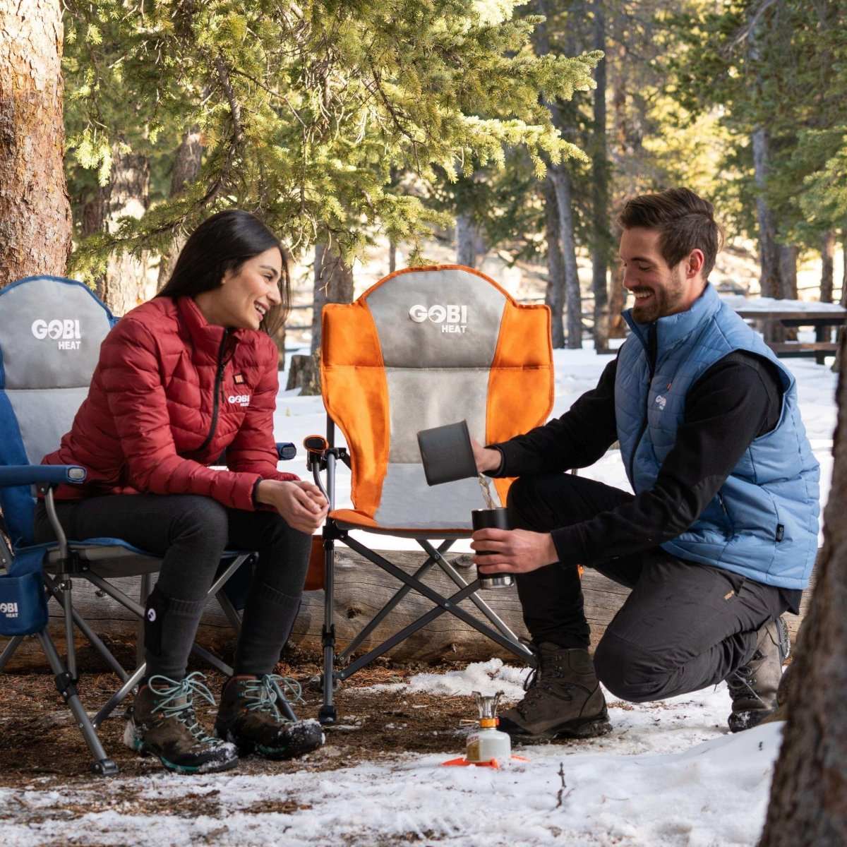 Heated camping chairs with solid steel frame and padded arms under trees.