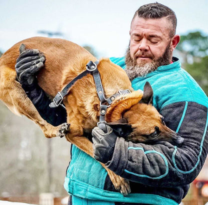 Man wearing Titan K-9 Gloves holding a trained dog.