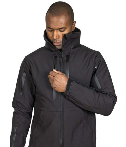 Man wearing Tradecraft Tactical Jacket 2.0 with waterproof zippers and high collar for protection and storage.