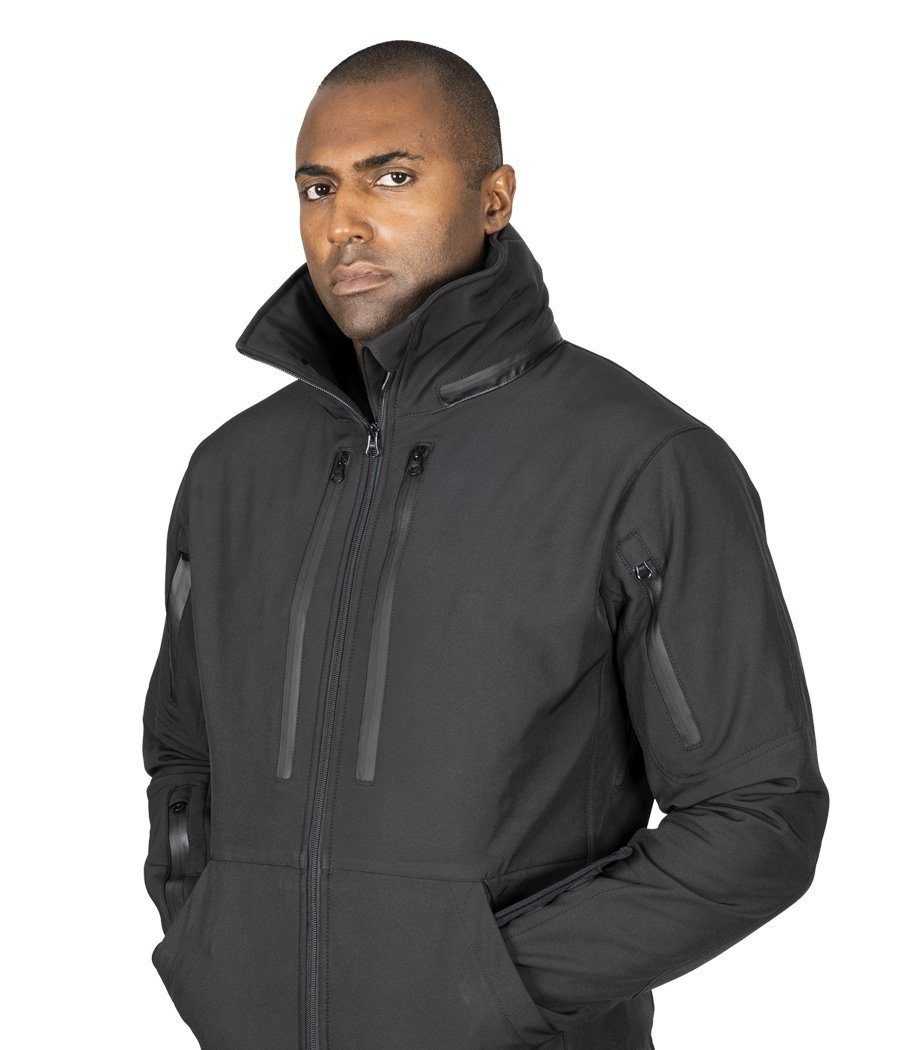 Man wearing black Tradecraft Tactical Jacket 2.0 with multiple pockets and high collar.