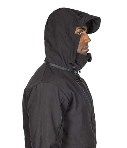 Man wearing Tradecraft Tactical Jacket 2.0 with hood, side view showing design features for protection and storage.