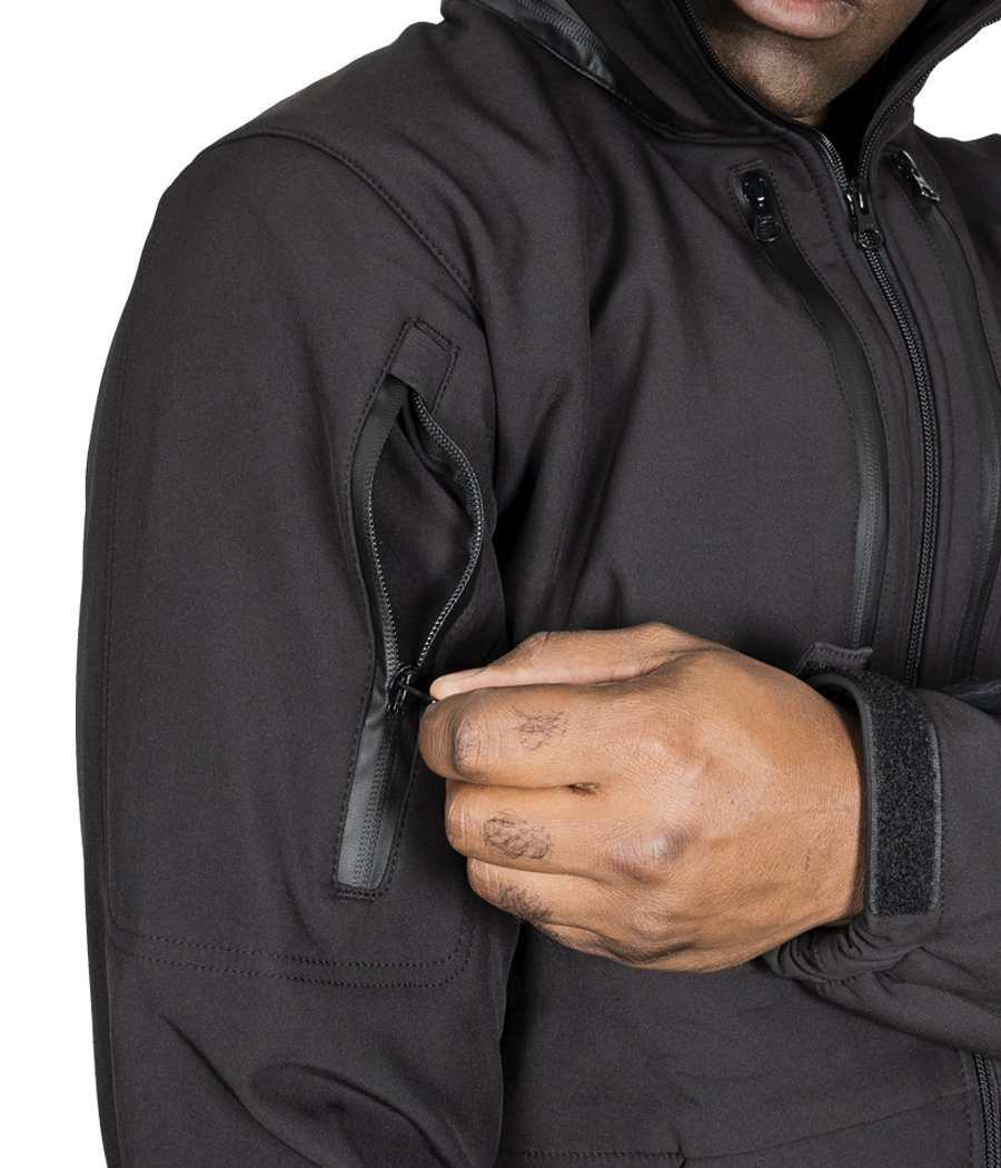 Black Tradecraft Tactical Jacket 2.0 with zippered sleeve pocket, designed for protection and utility.