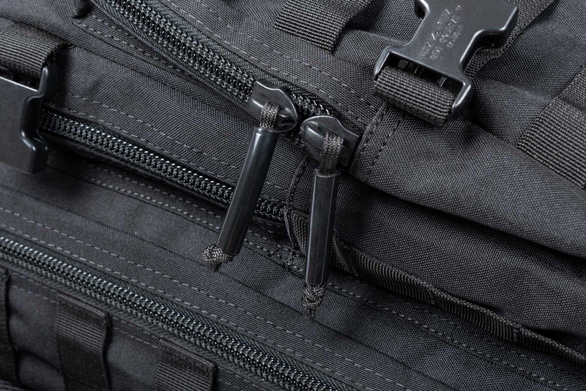 Close-up of the Ultimate Assault Backpack with durable zippers and MOLLE webbing for versatile use.