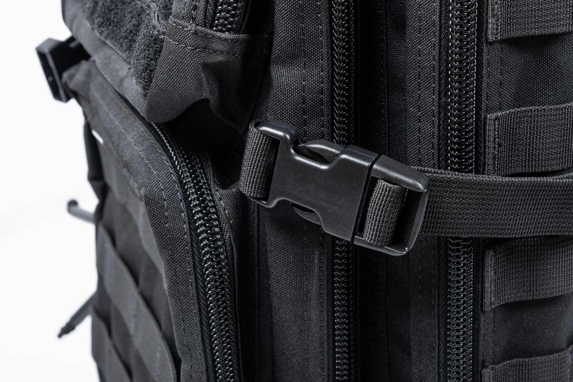 Close-up view of the Ultimate Assault Backpack's durable buckle and zipper system.