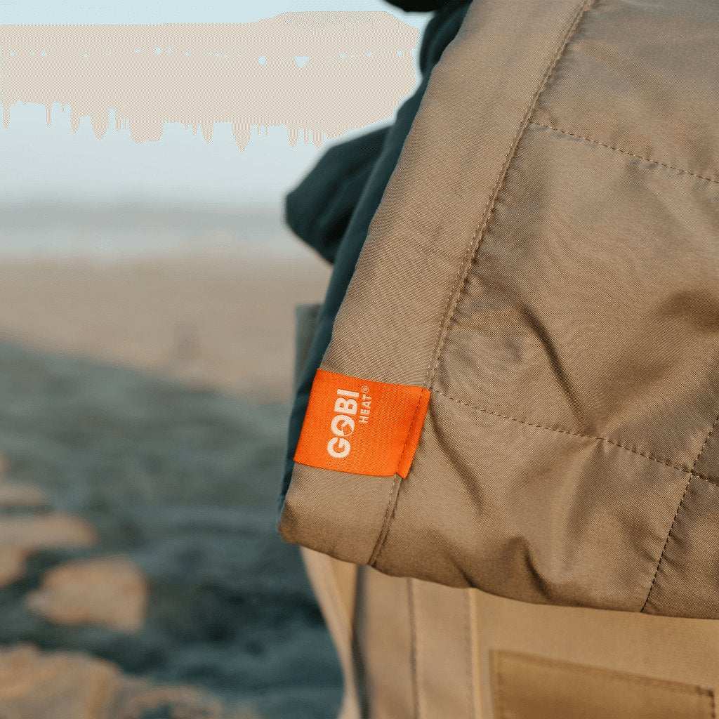 Zen Portable Heated Blanket on beach, showcasing portability and warmth.