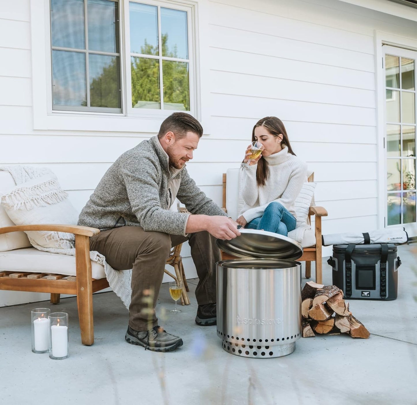 Stainless steel Solo Stove Bonfire Lid being used outdoors as a fire pit accessory for a cozy outdoor setting.