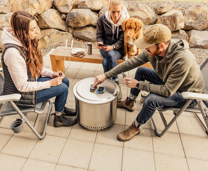 Outdoor gathering around Solo Stove Bonfire Lid used as a table.